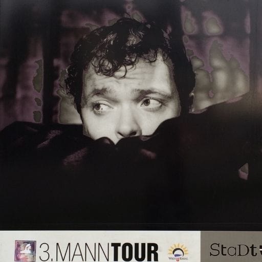 Film still of Orson Welles as Harry Lime in the 1949 noir film The Third Man, looking sideways in shadow.