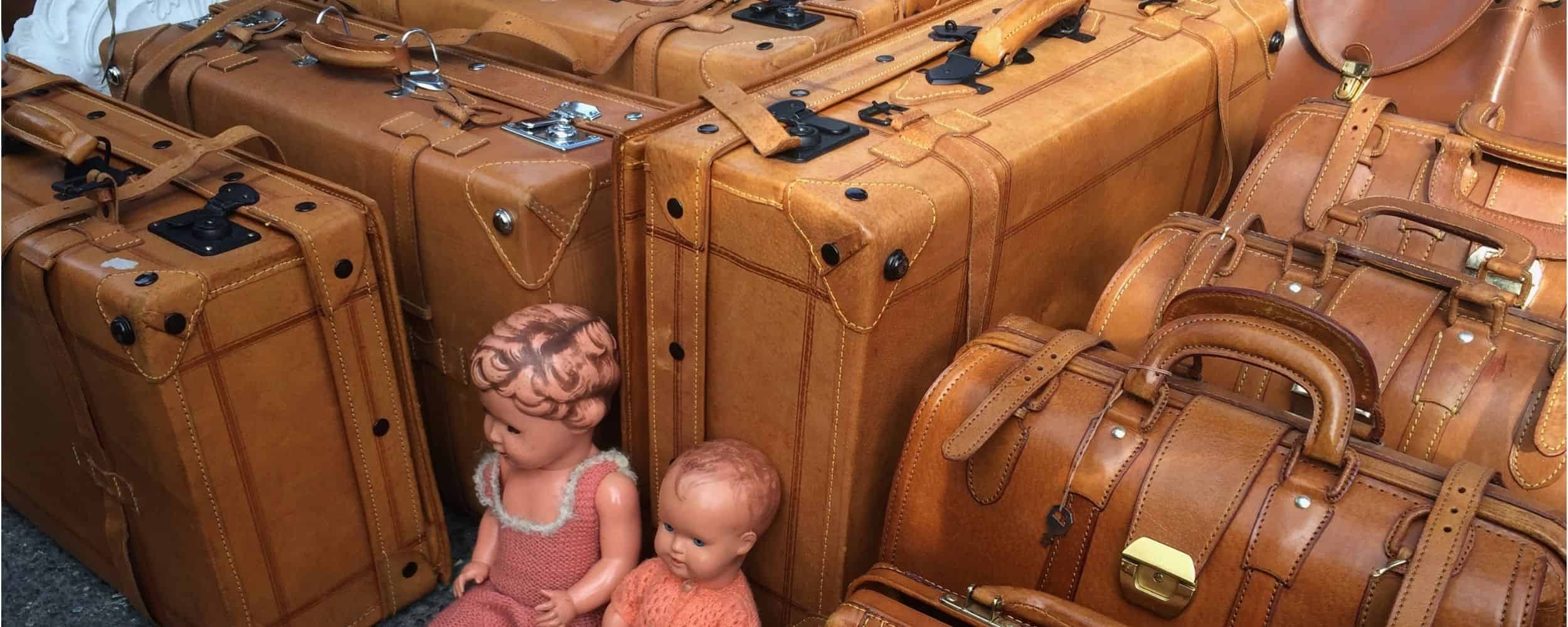 Vintage leather suitcases displayed at the Naschmarkt flea market in Vienna.