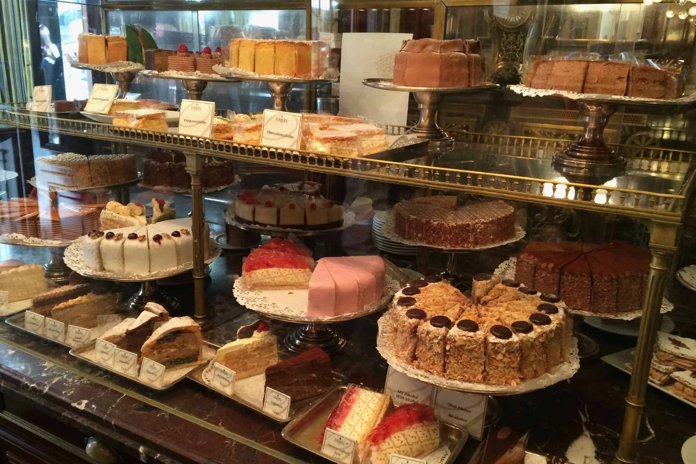 Café Demel, Vienna — traditional cakes displayed in the historic pastry case Assorted traditional cakes displayed in the glass pastry case at Café Demel in Vienna, arranged on tiered silver stands