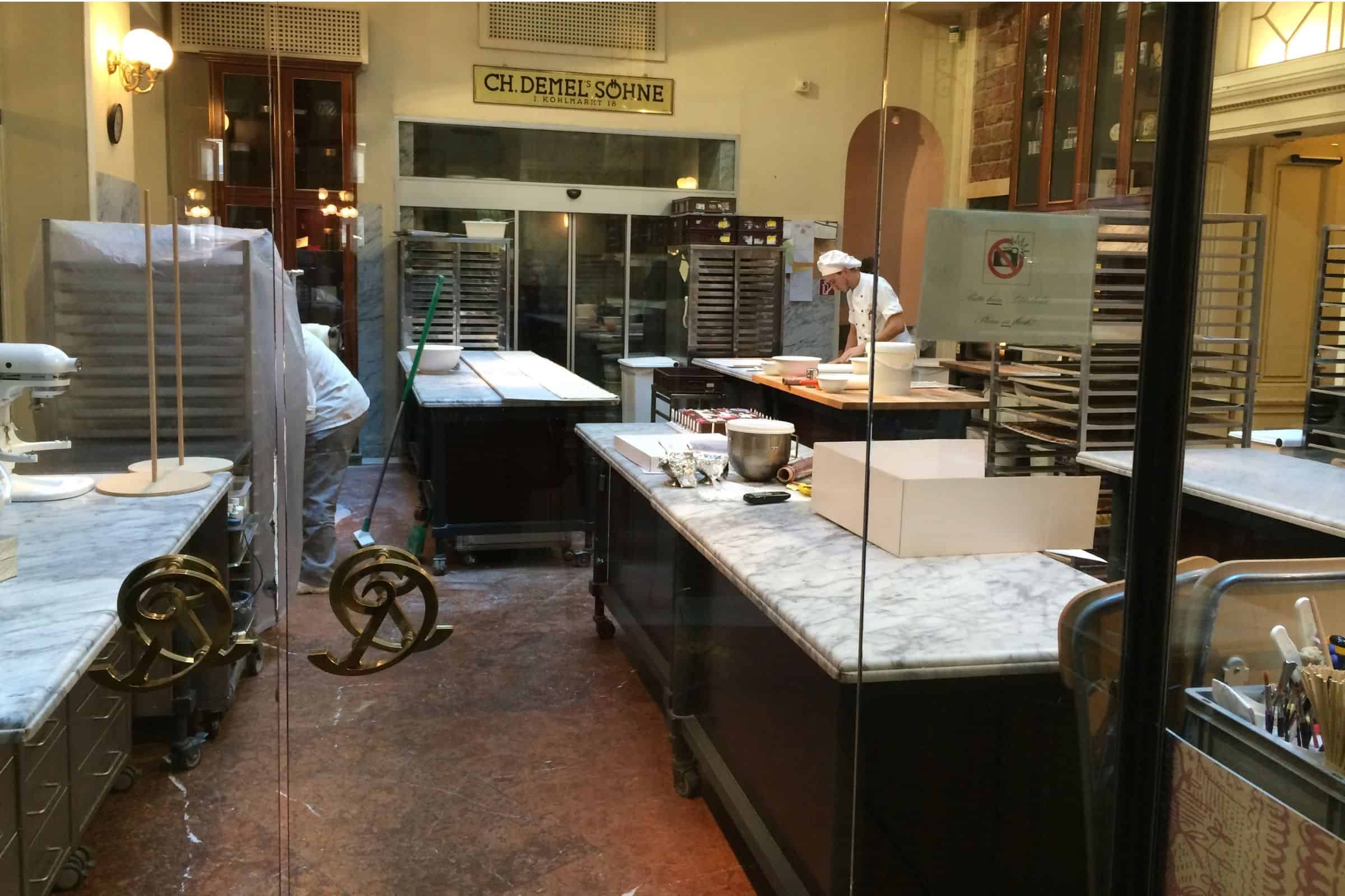 Café Demel, Vienna — pastry chefs working in the historic open kitchen Pastry chefs preparing delicacies at the famed Cafe Demel in Vienna