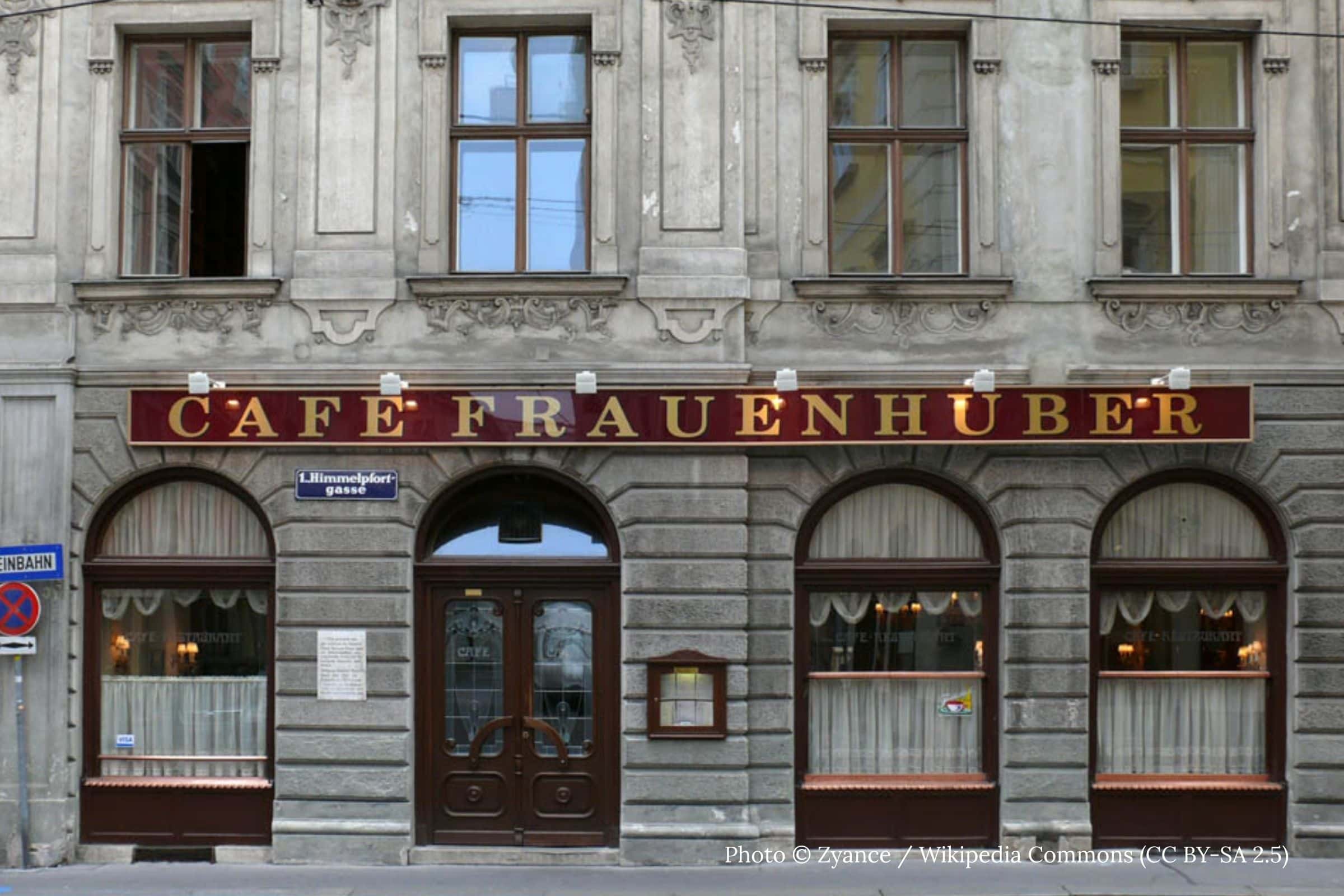 Café Frauenhuber Vienna historic exterior on Himmelpfortgasse Exterior of Café Frauenhuber in Vienna with historic stone façade arched windows and burgundy café sign