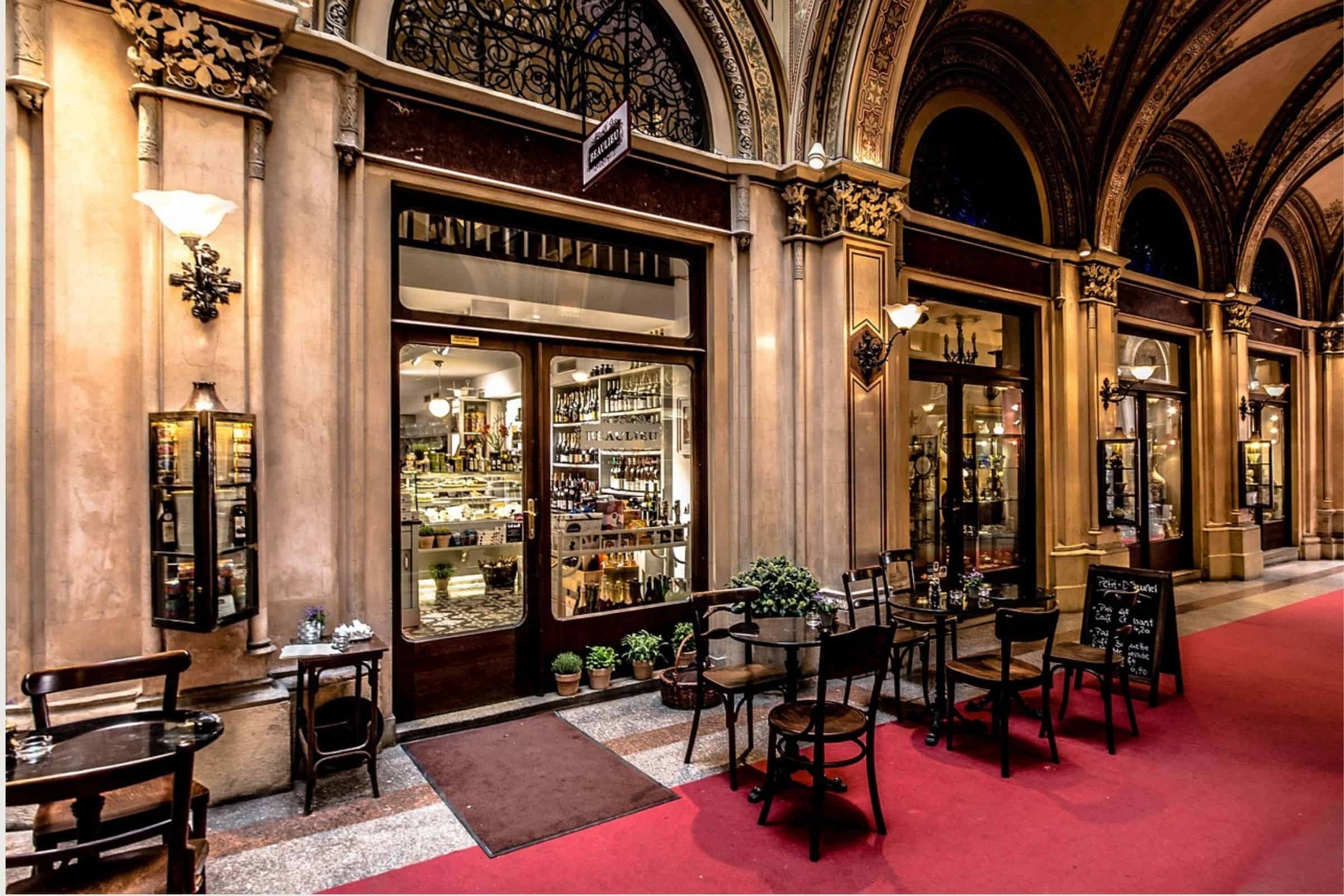 Ferstel Passage cafés and arcade in Vienna Ferstel Passage in Vienna with historic arcades, café tables, and illuminated shopfronts