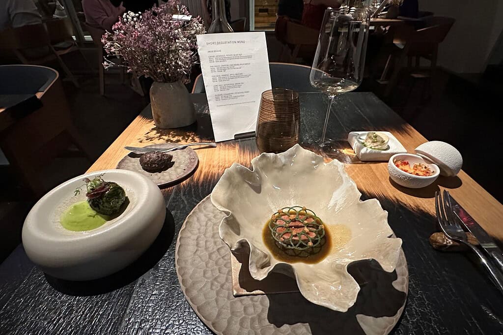 Creative tasting menu at Field Prague featuring sculptural ceramic plating, a refined caviar and gold–garnished course, and a precisely composed meat dish in an intimate fine-dining setting.