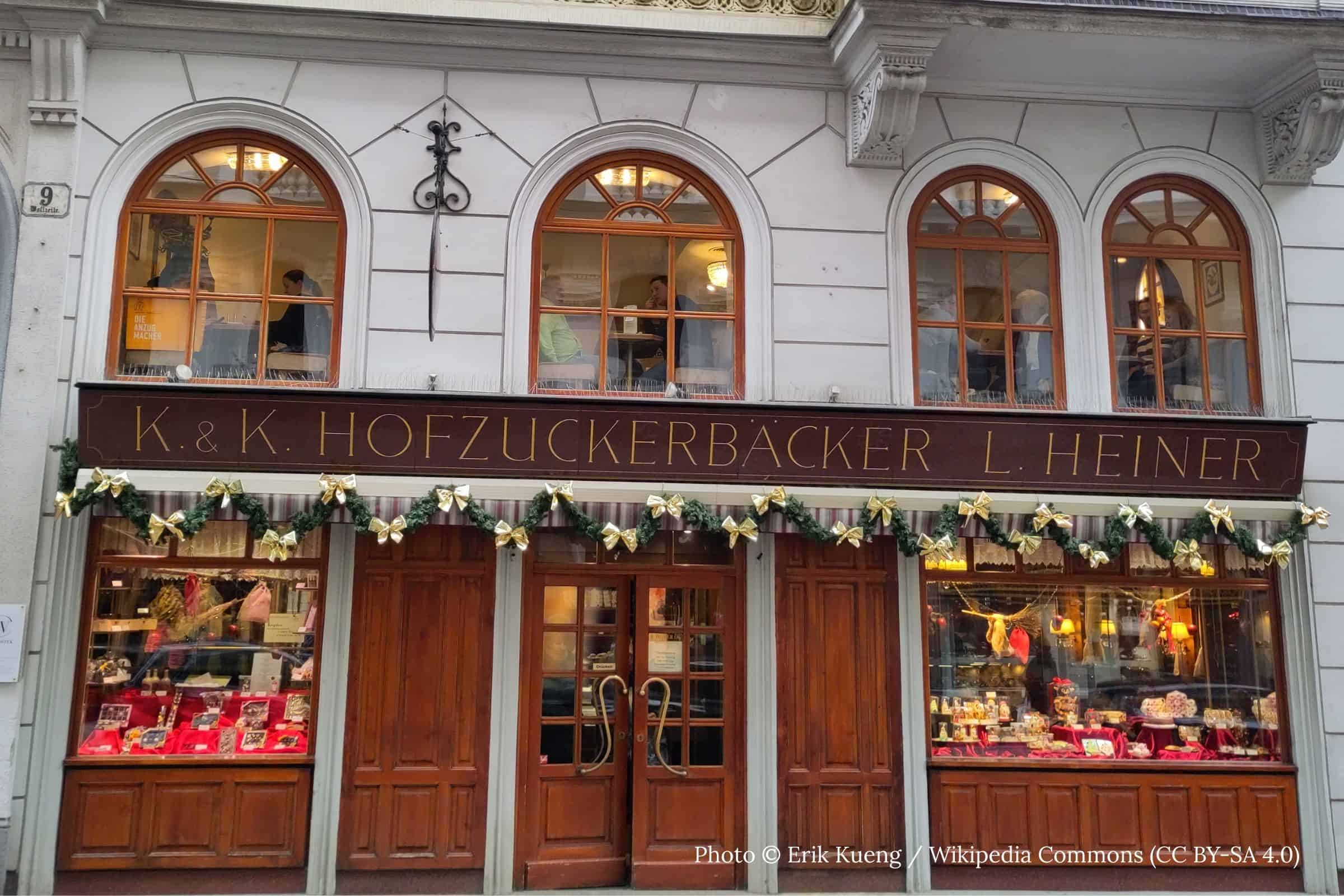 K u k Hofzuckerbäcker L Heiner Vienna pastry windows and historic facade K u k Hofzuckerbäcker L Heiner Vienna exterior with illuminated pastry windows and historic signage