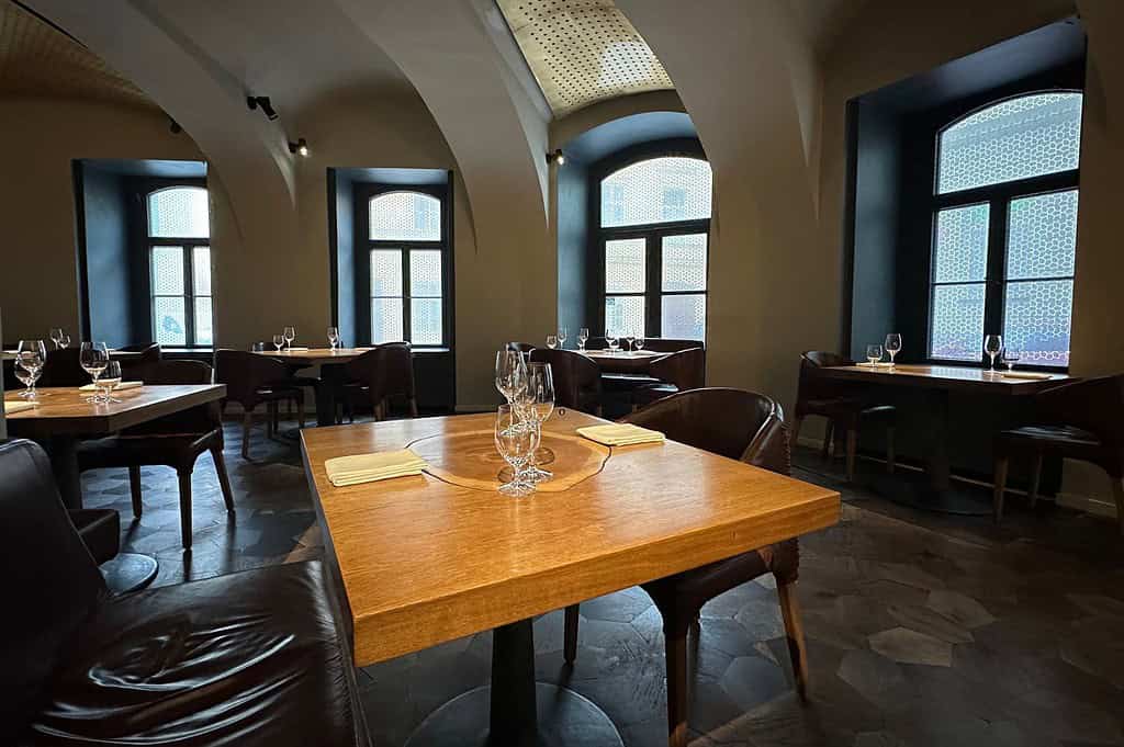 FIELD Prague dining room with vaulted ceilings and set wooden tables
