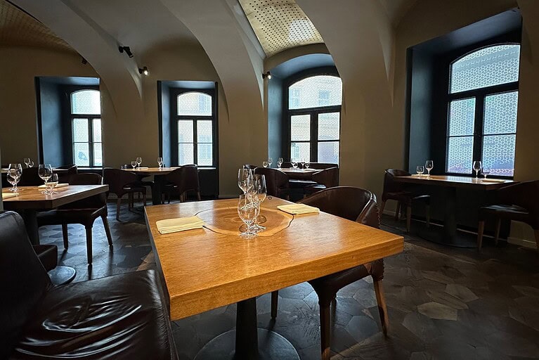 FIELD Prague dining room with vaulted ceilings and set wooden tables