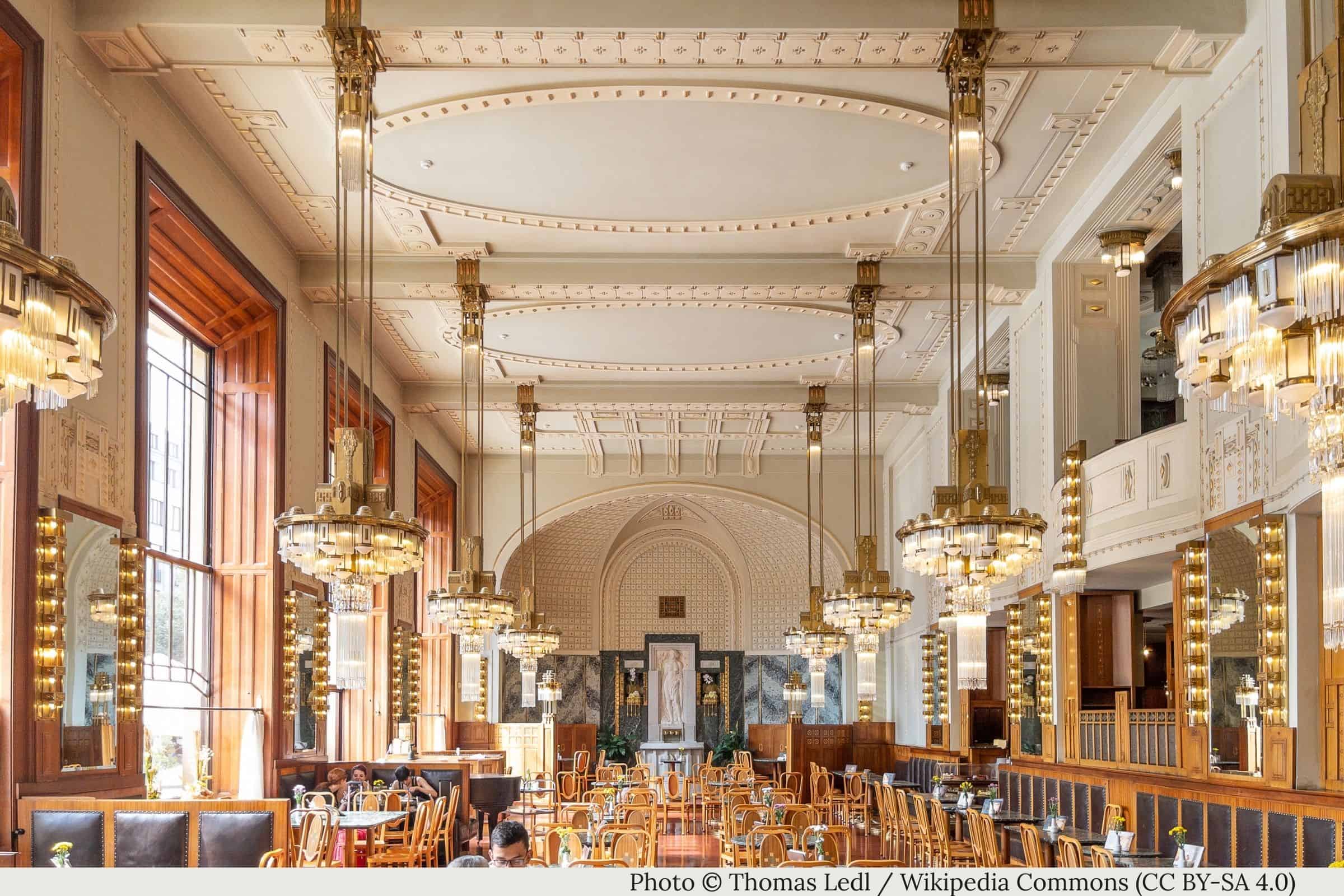 Municipal House Cafe Prague interior with Art Nouveau chandeliers, mirrors, and wood paneling