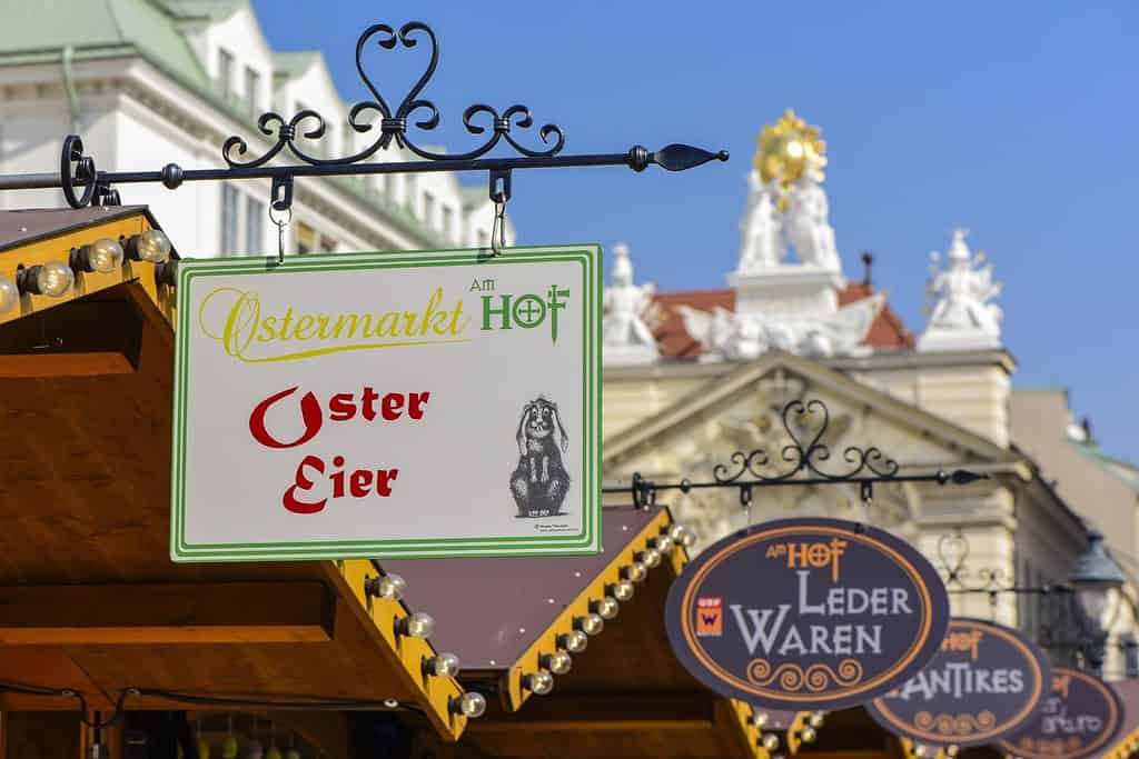 Sign for the Am Hof Easter Market (Ostermarkt am Hof) in Vienna with the Kirche am Hof in the background