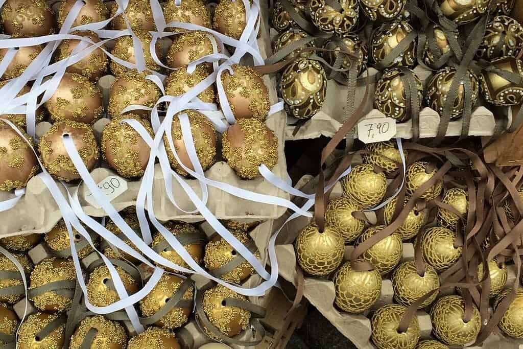 Metallic gold hand-painted and beaded Easter eggs with ribbon hangers at the Freyung Easter Market in Vienna