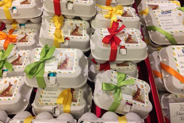 Colorful Easter chocolate eggs packaged in ribbon-tied gift boxes at a Vienna confectionery