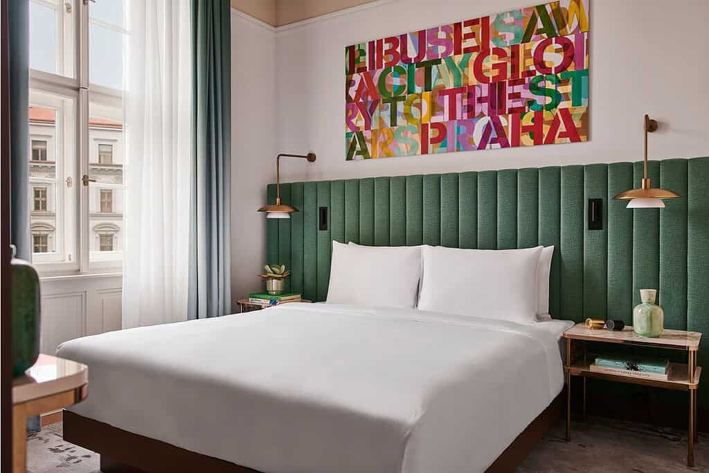 Guest rooms and restaurant interiors at Andaz Prague in the historic Sugar Palace, showcasing contemporary Czech-inspired design, sculptural art details, and the MEZ restaurant dining room