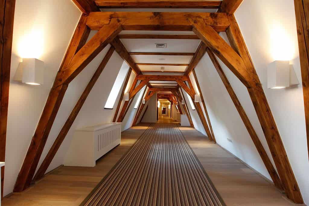 Augustine, a Luxury Collection Hotel Prague corridor with exposed monastery beams, Refectory Bar cocktail under vaulted ceiling, and two-level suite interior