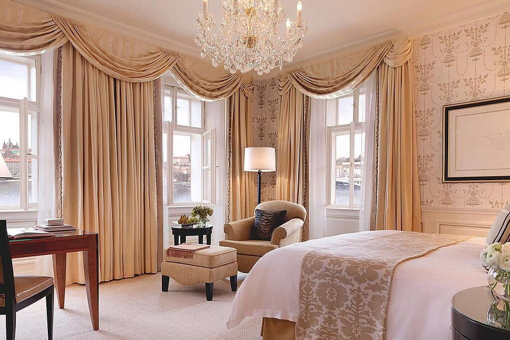 Riverside exterior, elegant guest room with Vltava River views, and lounge interior at the Four Seasons Hotel Prague near Charles Bridge.