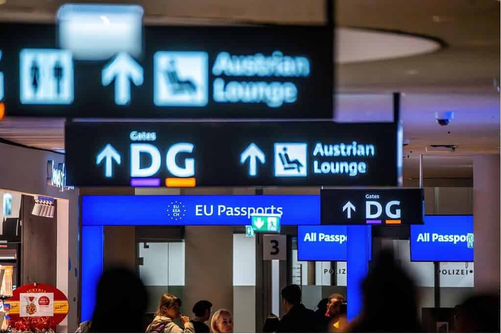Passport-control signs for EU and all-passport lanes at Vienna International Airport