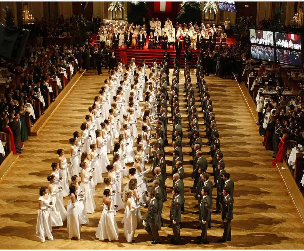 Debutantes in white gowns and escorts in formal military dress at the Ball der Offiziere in Vienna’s Hofburg