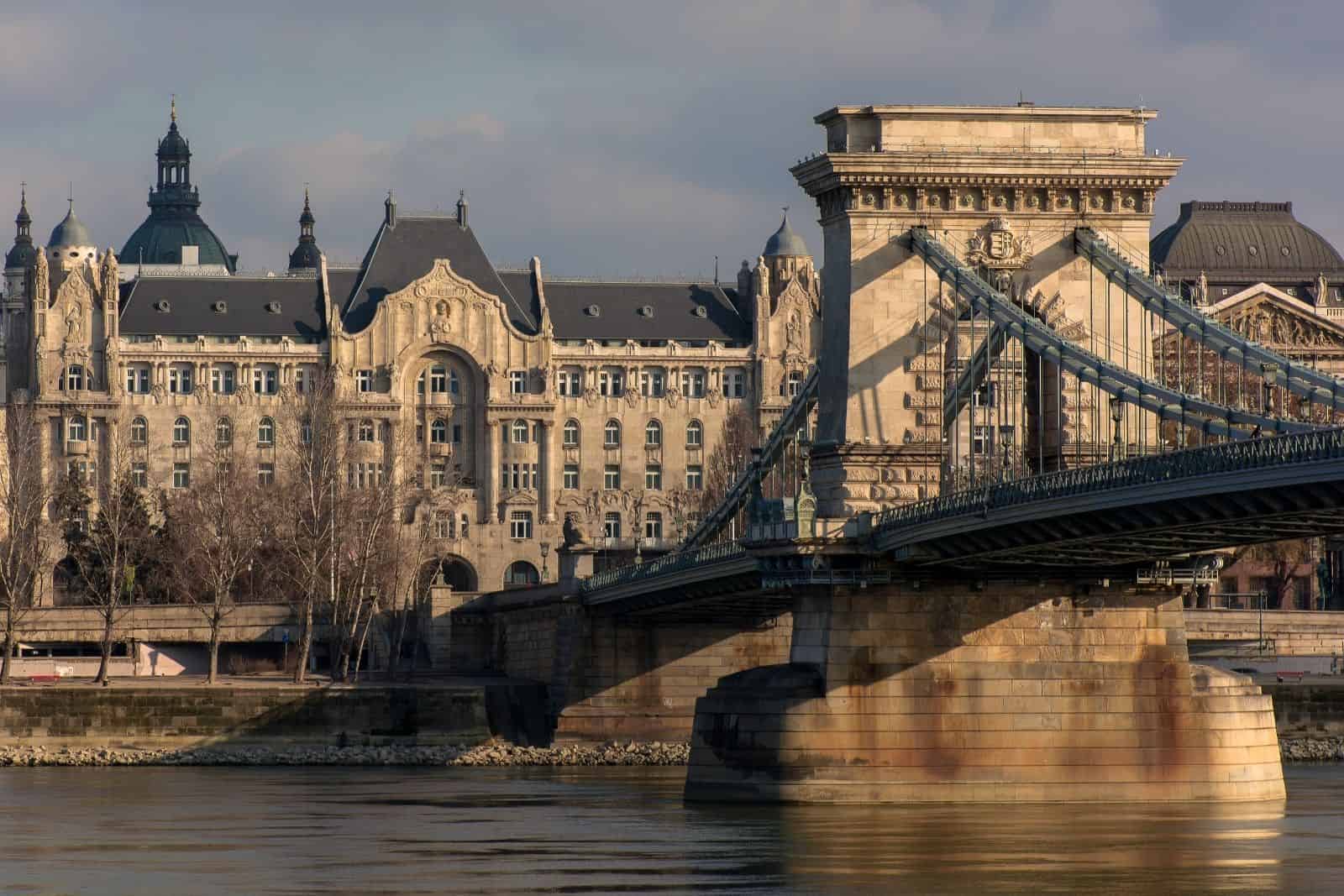 View of the Széchenyi Chain Bridge over the Danube with the Gresham Palace hotel at dusk