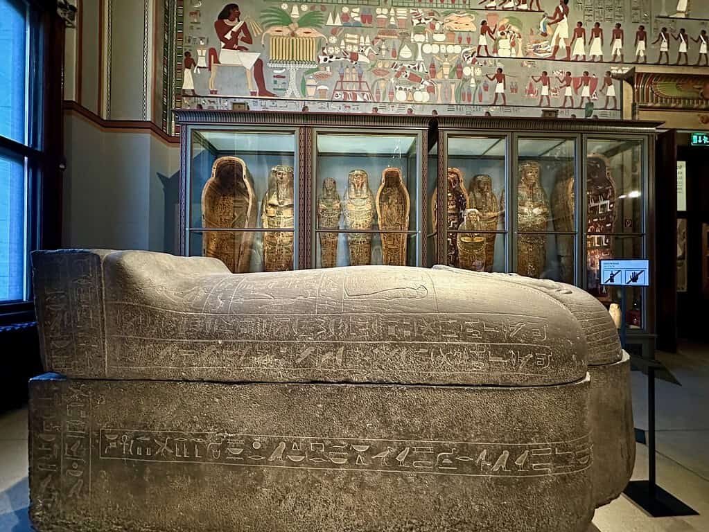 Stone sarcophagus and mummified remains displayed in the Egyptian and Near Eastern Collection at the Kunsthistorisches Museum, Vienna