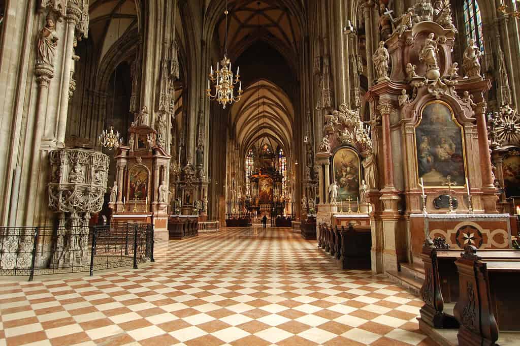 Interior of St. Stephen’s Cathedral in Vienna, showing the Gothic nave, stone columns, vaulted ceiling, and rows of pews