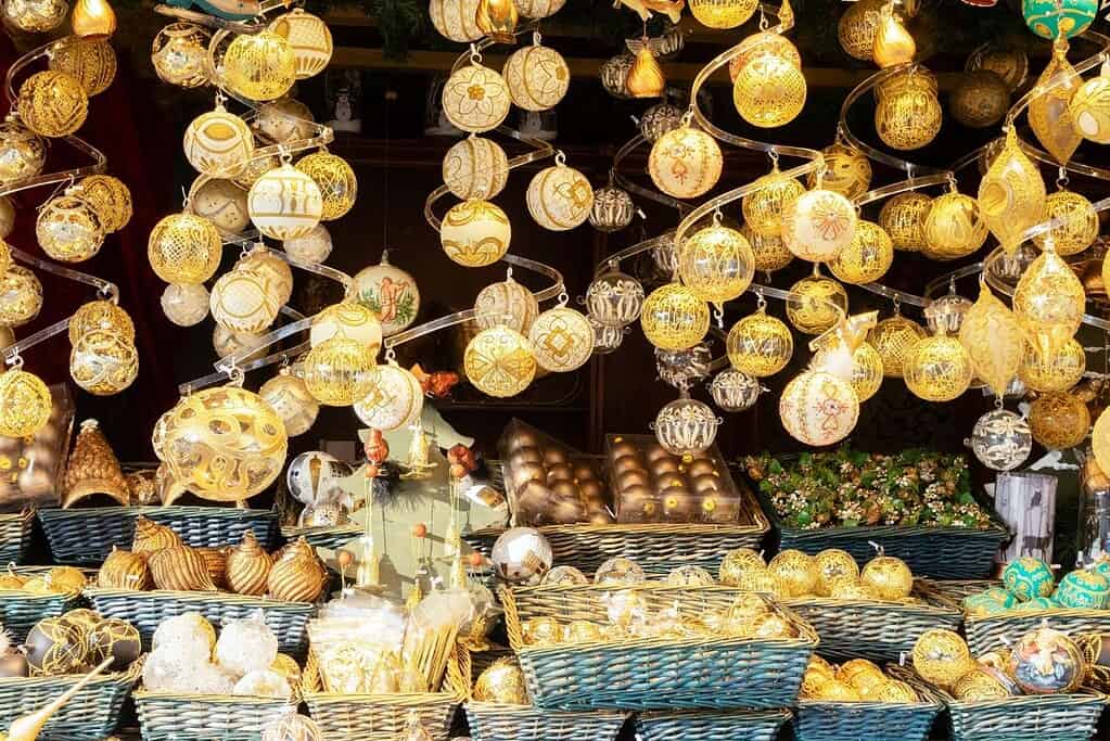 Gold Christmas ornaments hanging in a market stall in Vienna, Austria